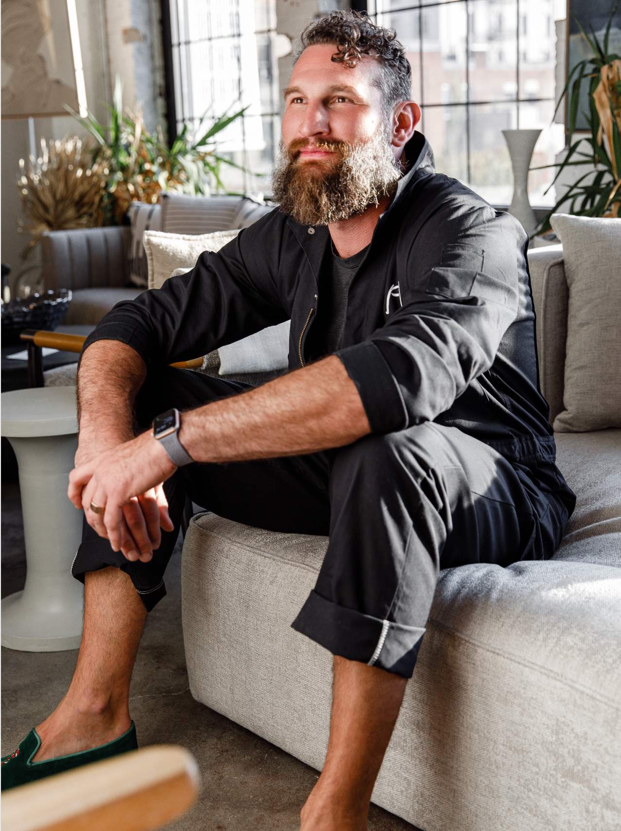 zach gourde, seated on a cool couch