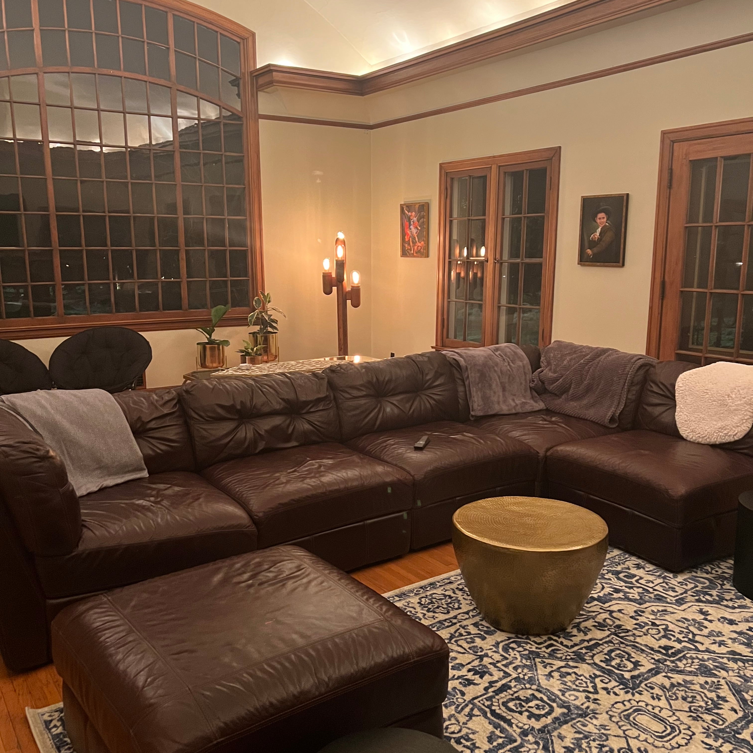 a dark sectional in a living room space before day with a designer