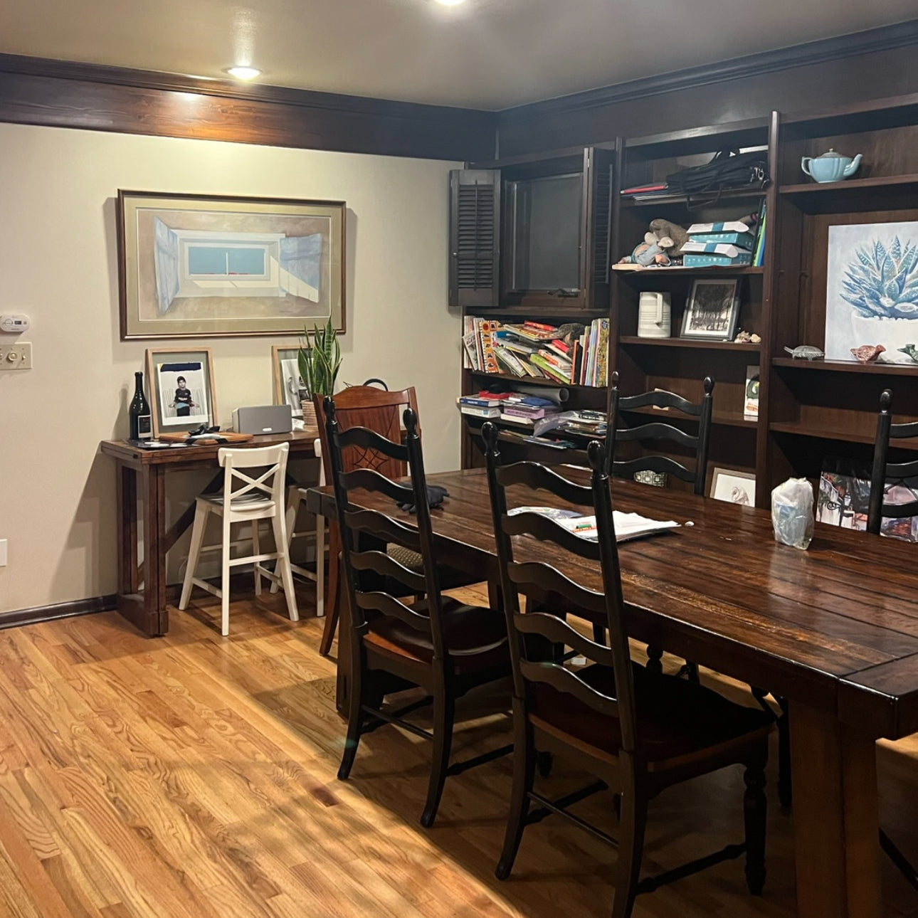 a dark, dingy dining room space before day with a designer