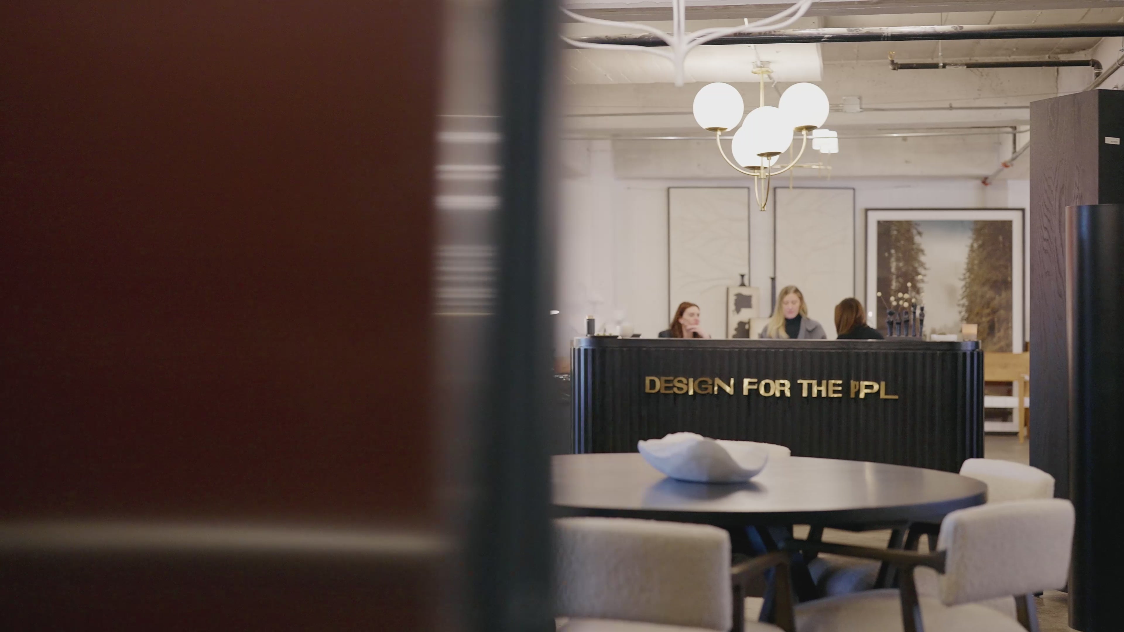 a video of the interior of design for the ppl's showroom, with the team members seated behind the front desk and the owner Erin Haskell walking amongst her beautiful decor and furniture